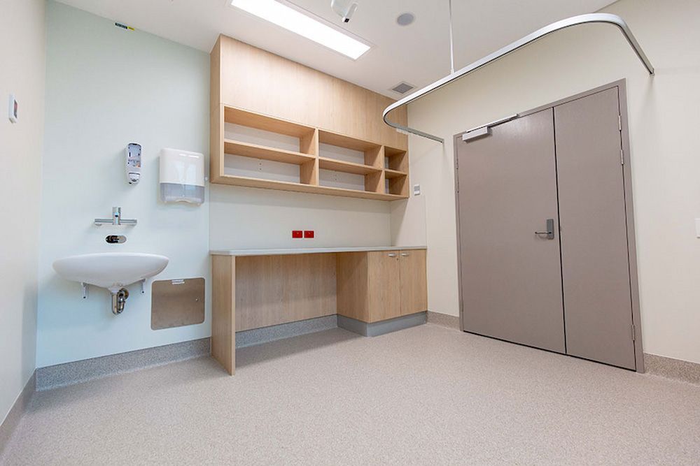 A Hospital Room With a Sink, Shelves, and a Door — Nick Favot Painting in Bohle, QLD