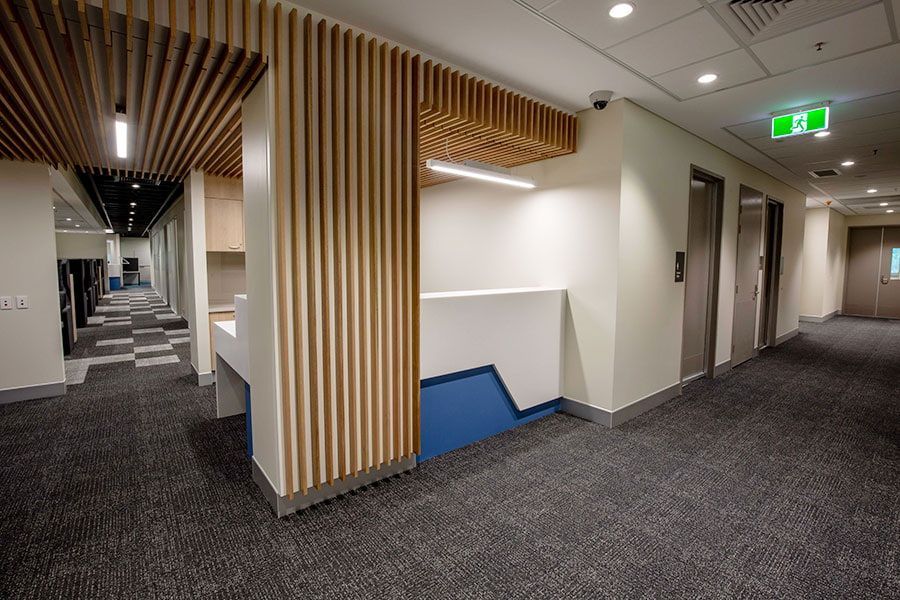 A Long Hallway With a Reception Desk in the Middle of It — Nick Favot Painting in Bohle, QLD