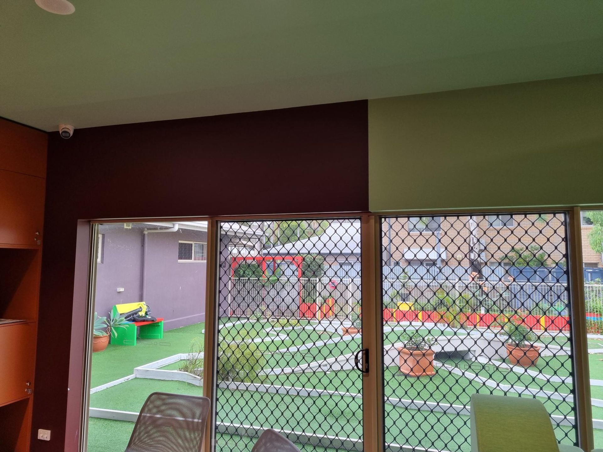 A Room With a Sliding Glass Door Looking Out to a Garden — Nick Favot Painting In Bohle, QLD