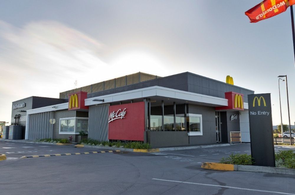 A Mcdonald's Restaurant With a Parking Lot in Front of It — Nick Favot Painting in Bohle, QLD