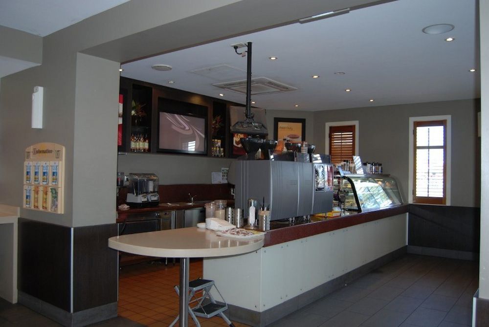 A Restaurant With a Long Counter and a Small Table — Nick Favot Painting in Bohle, QLD