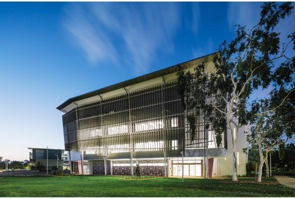A Large Building With a Lot of Windows and Trees in Front of It — Nick Favot Painting in Bohle, QLD