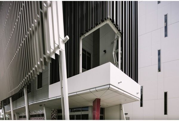 A Building With a Balcony on the Side of It — Nick Favot Painting in Bohle, QLD