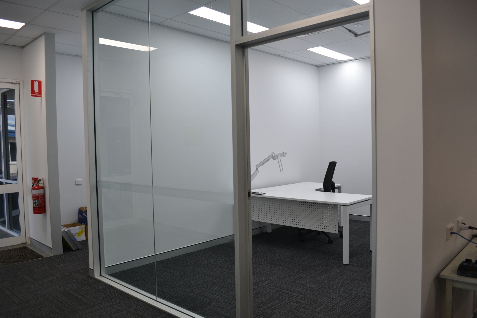 Office With Glass Walls, Featuring a Desk and a Chair — Nick Favot Painting In Bohle, QLD