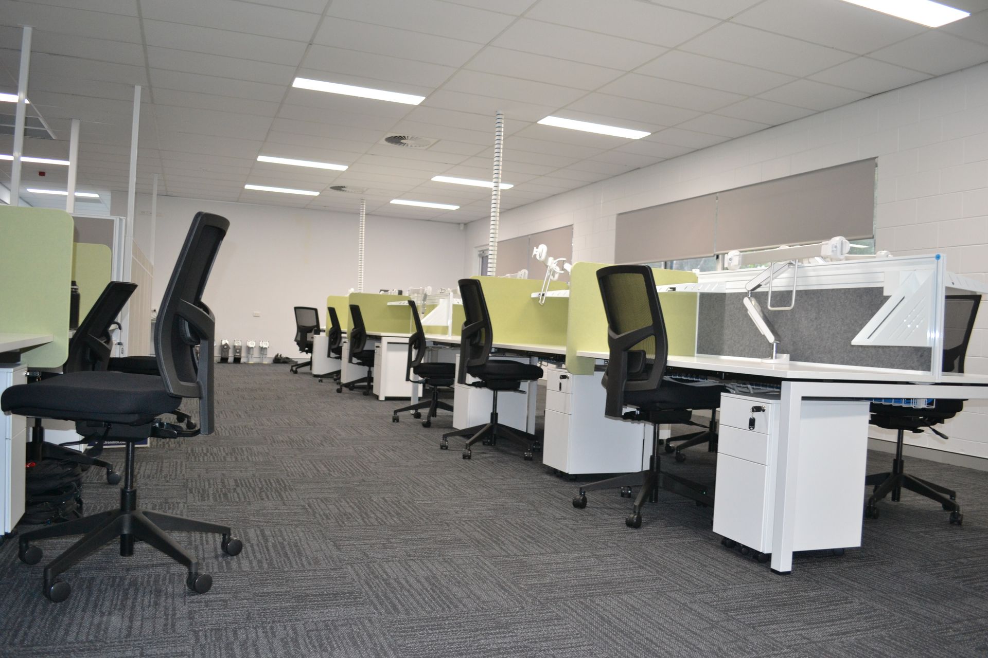 Office With Rows of Black Chairs and Green Partitioned Desks — Nick Favot Painting In Bohle, QLD