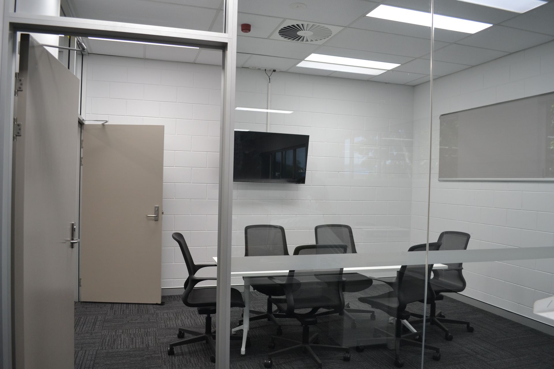 Modern Conference Room With White Table Surrounded by Chairs — Nick Favot Painting In Bohle, QLD