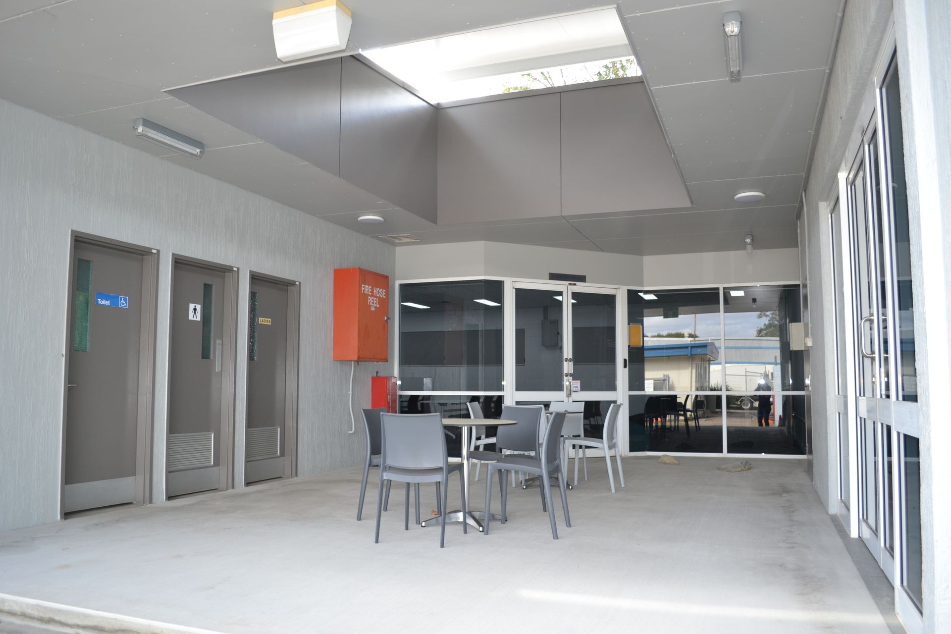 Outdoor Patio With Grey Chairs and Tables — Nick Favot Painting In Bohle, QLD