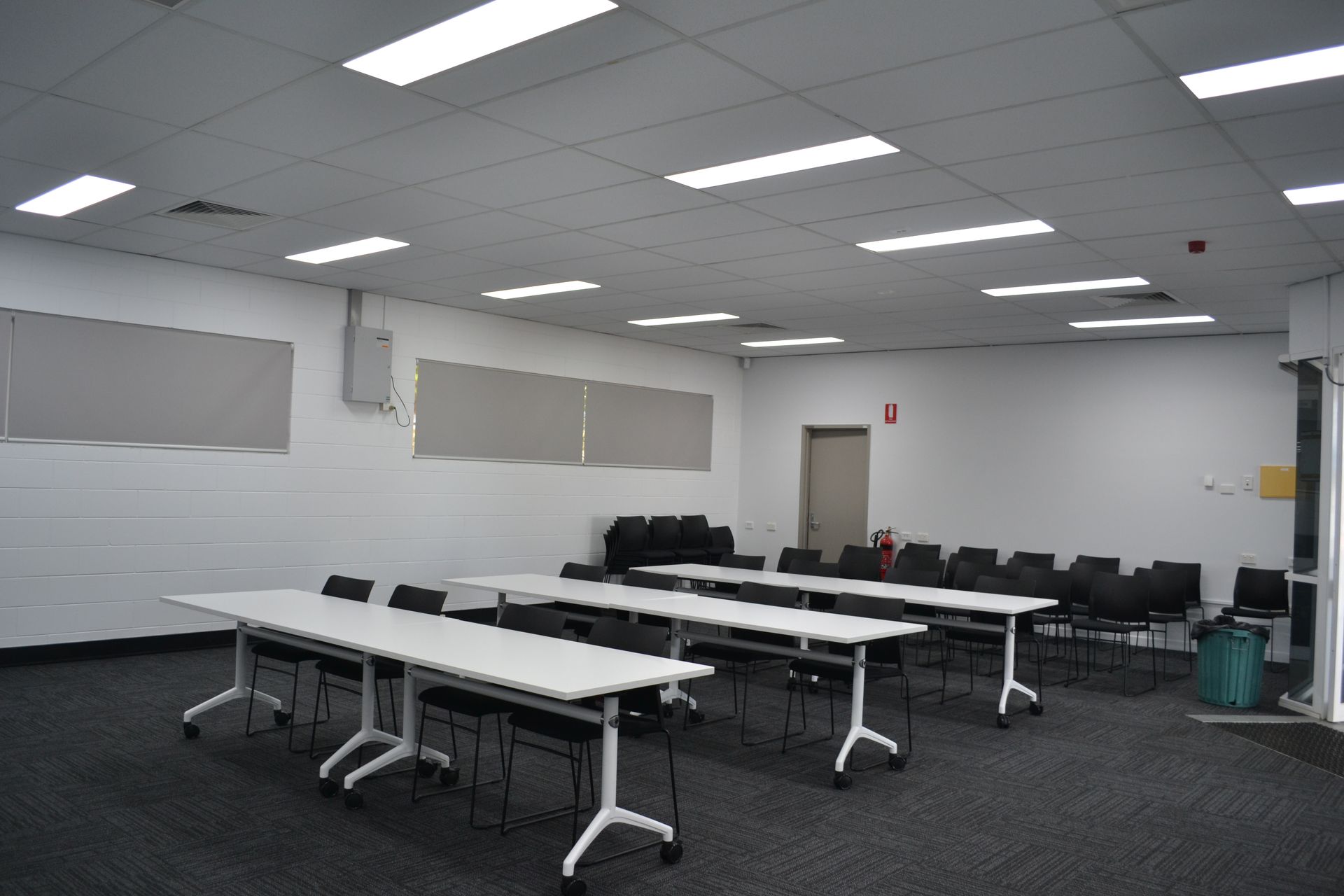 A Modern Room With Rows of White Tables and Black Chairs — Nick Favot Painting In Bohle, QLD