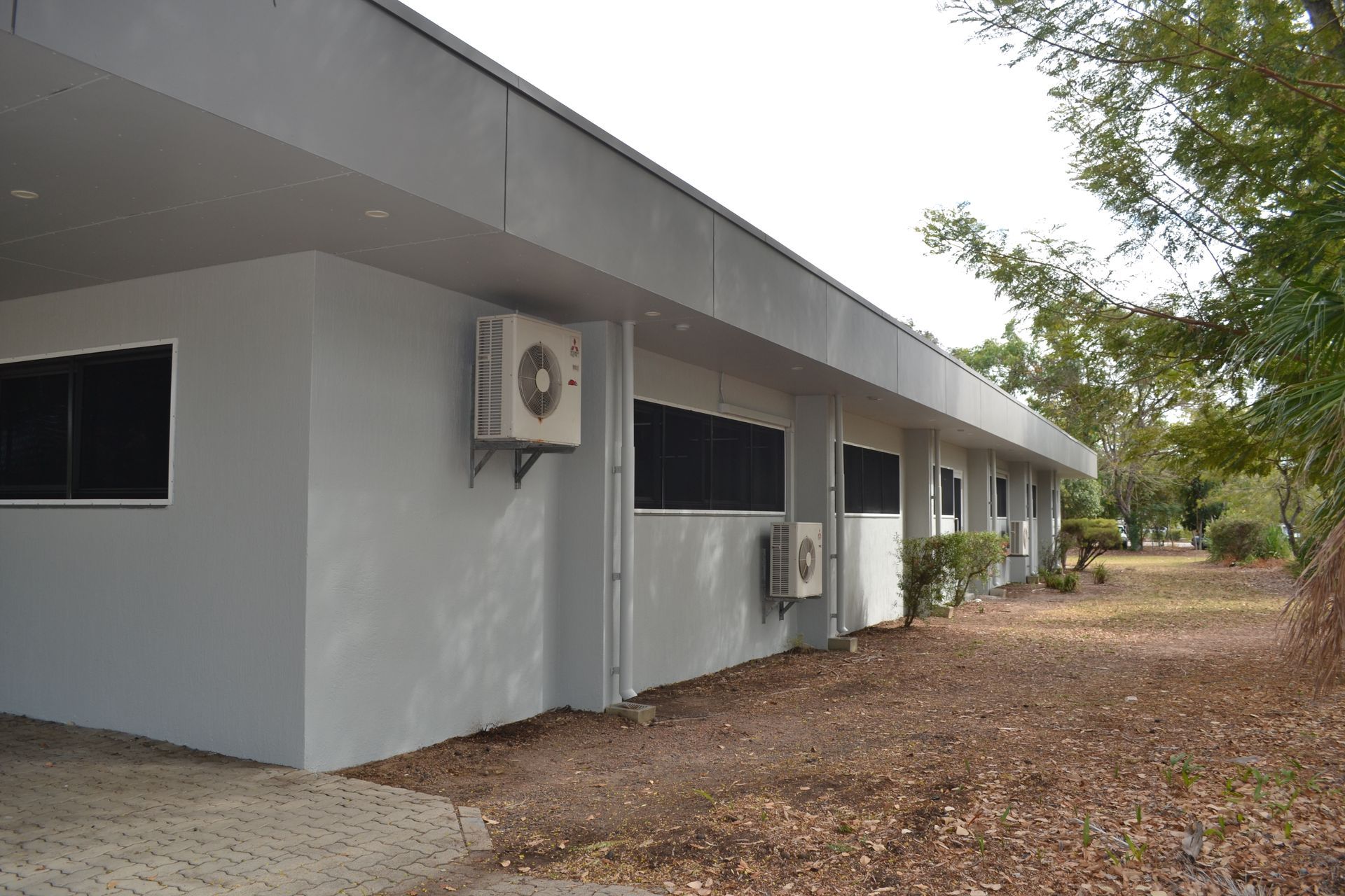 Light Grey Building With Air Conditioning Units — Nick Favot Painting In Bohle, QLD