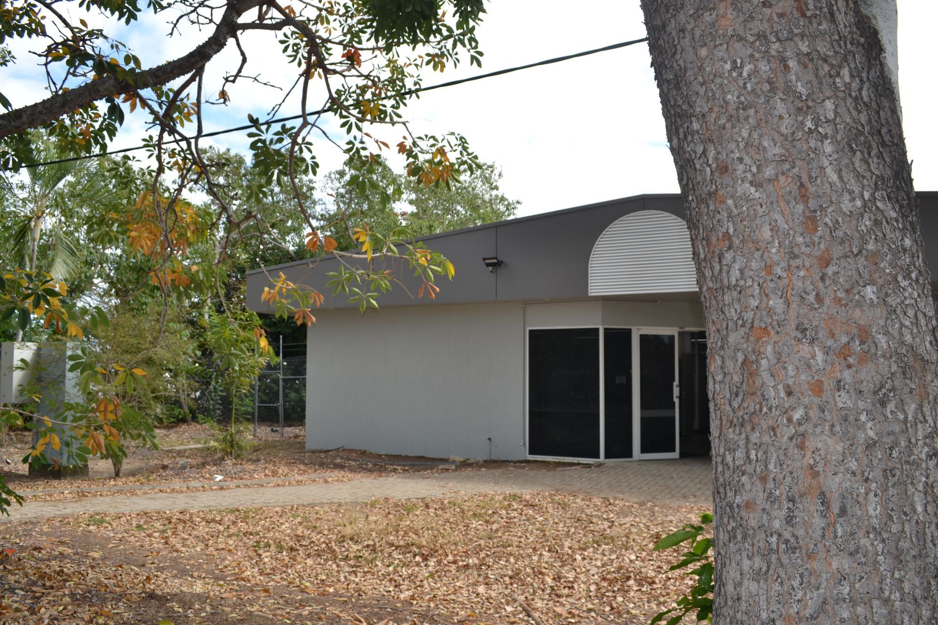 A Modern Building With Large Glass Doors — Nick Favot Painting In Bohle, QLD
