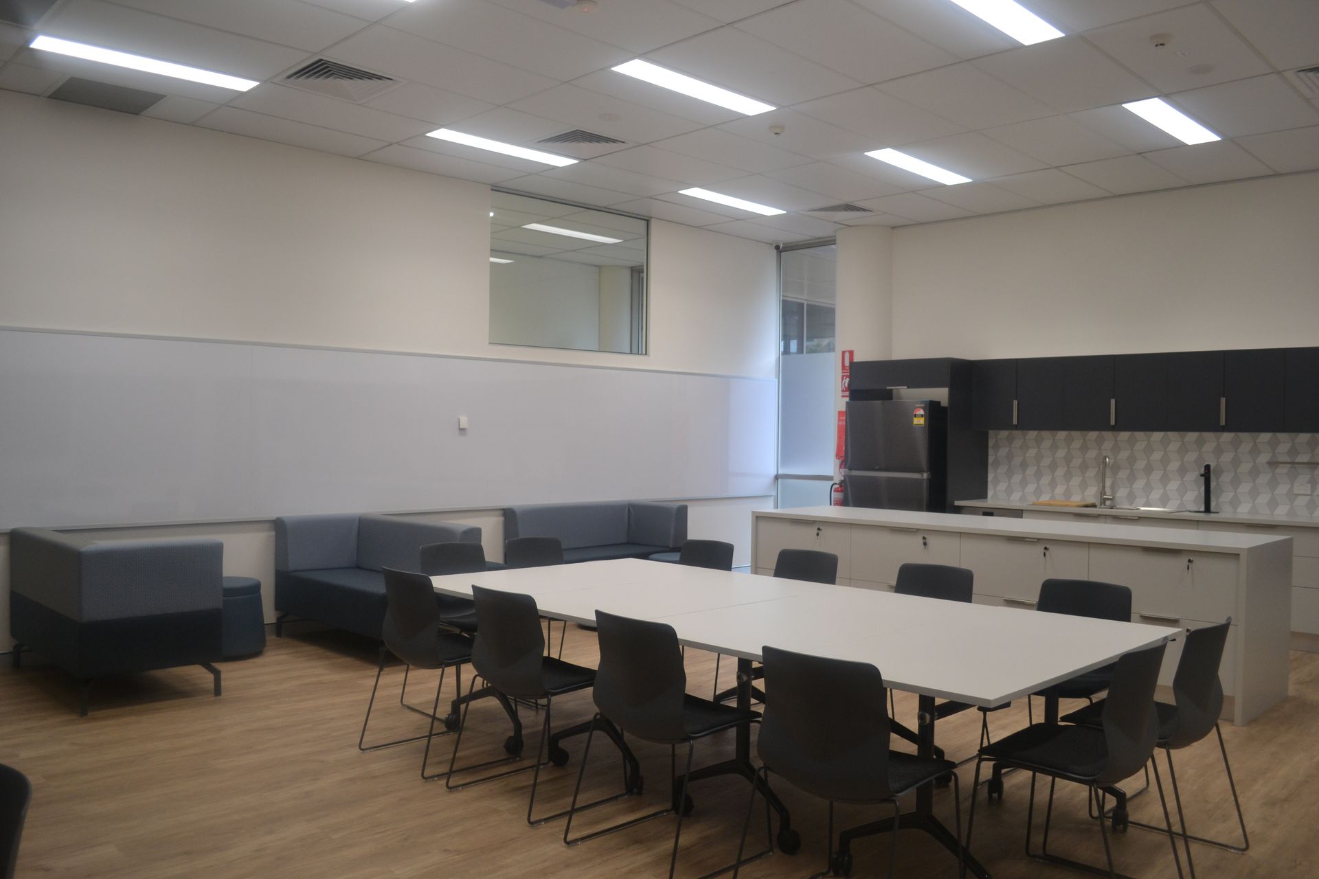 Modern Office Kitchen With Light Wood Flooring — Nick Favot Painting In Bohle, QLD