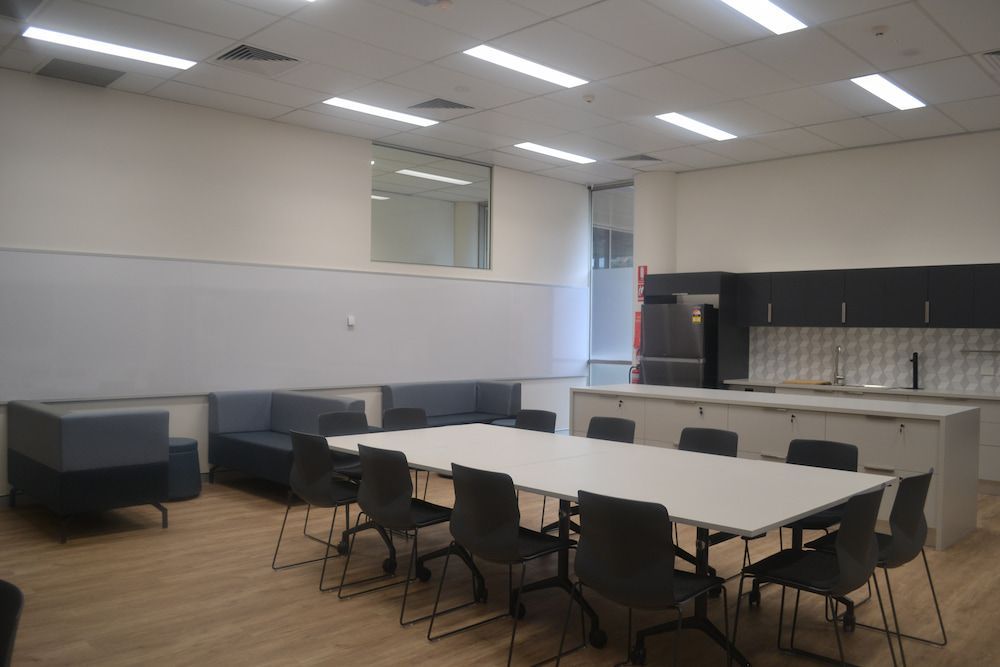 A Room With a Long Table and Chairs in It — Nick Favot Painting in Bohle, QLD