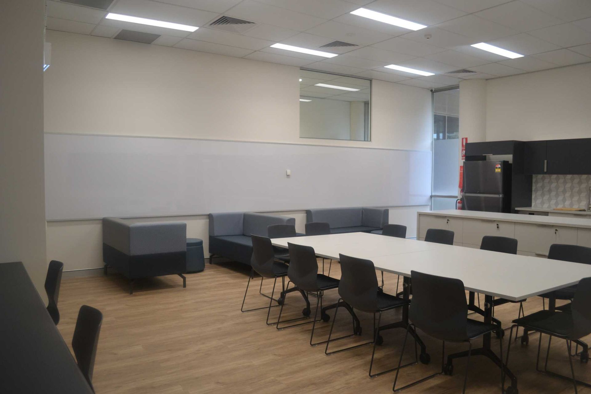 A Department of Youth Justice Refurb Room With a Long Table and Chairs in It — Nick Favot Painting in Bohle, QLD