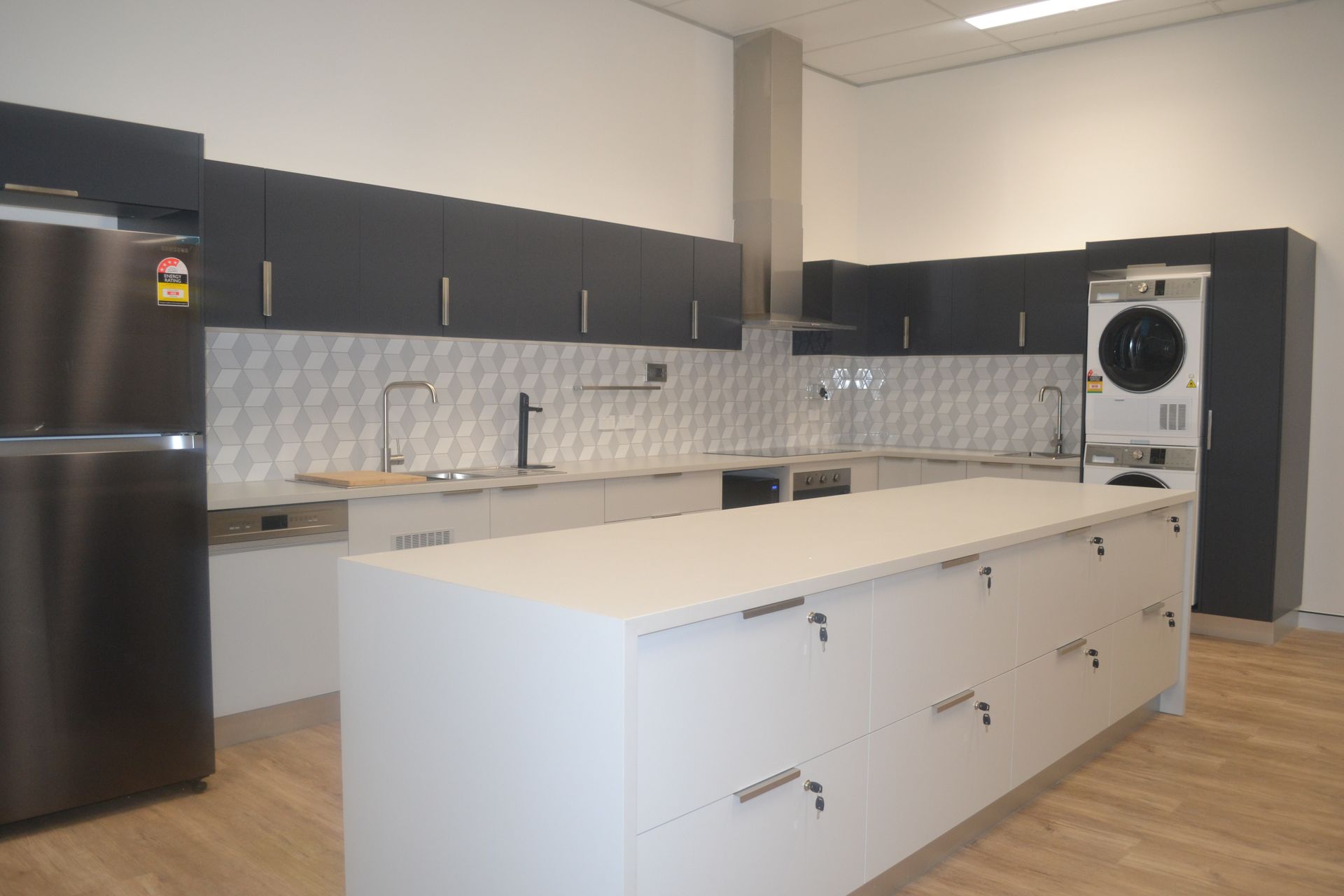 Modern Kitchen With a Large White Island — Nick Favot Painting In Bohle, QLD
