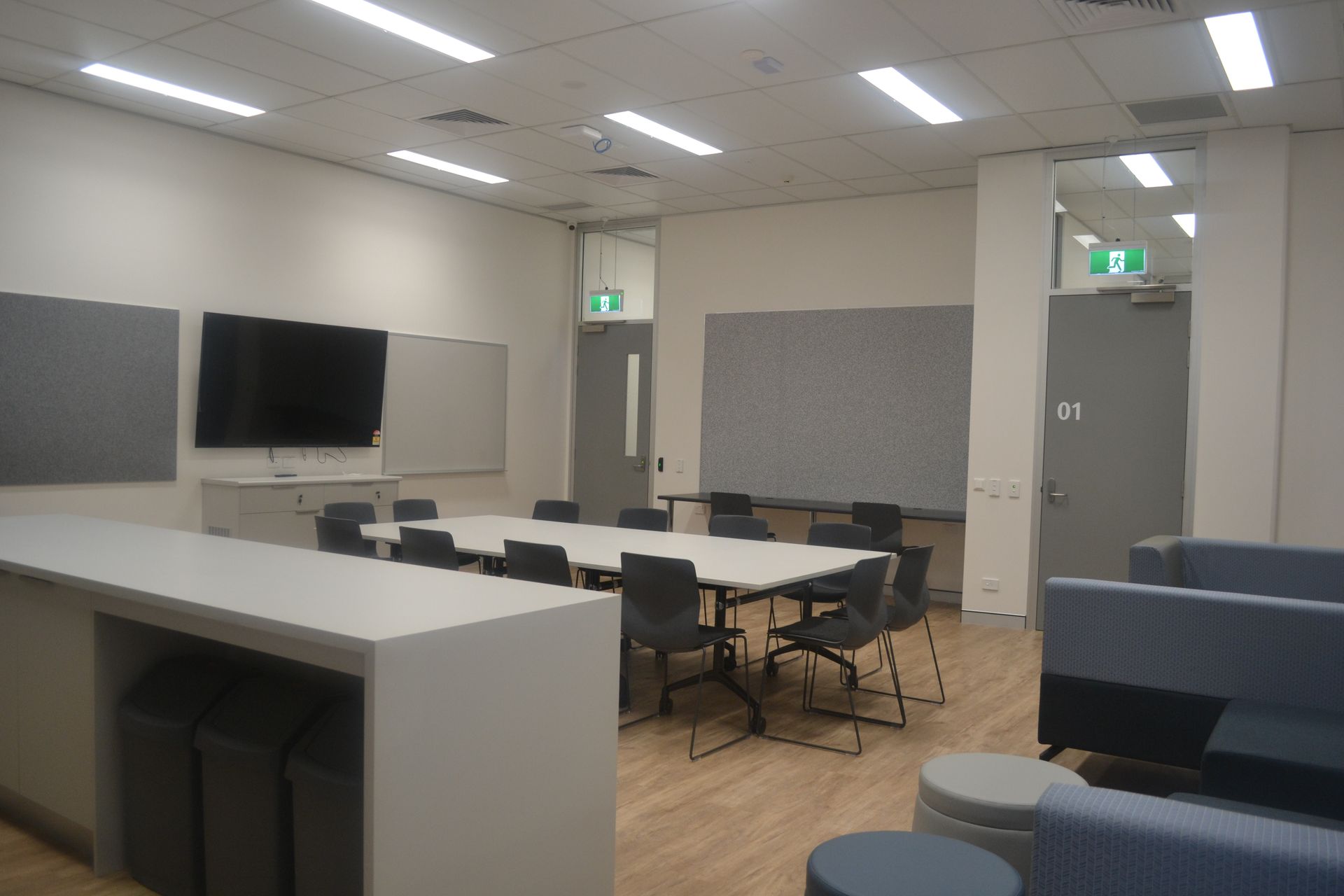 Room With White Tables, Grey Chairs, and a Wall-mounted TV — Nick Favot Painting In Bohle, QLD