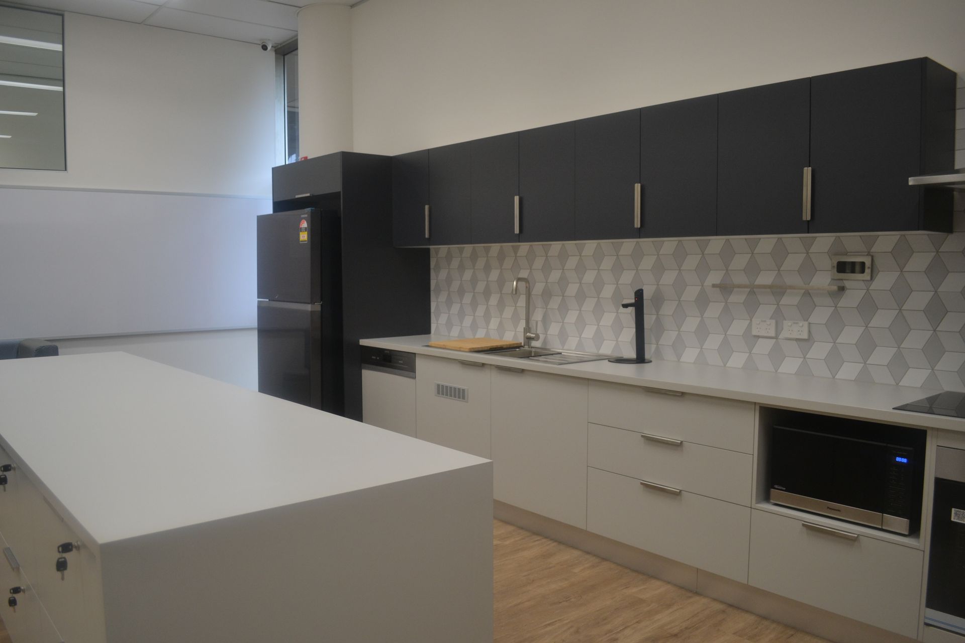 Modern Kitchen With Black and White Cabinets — Nick Favot Painting In Bohle, QLD