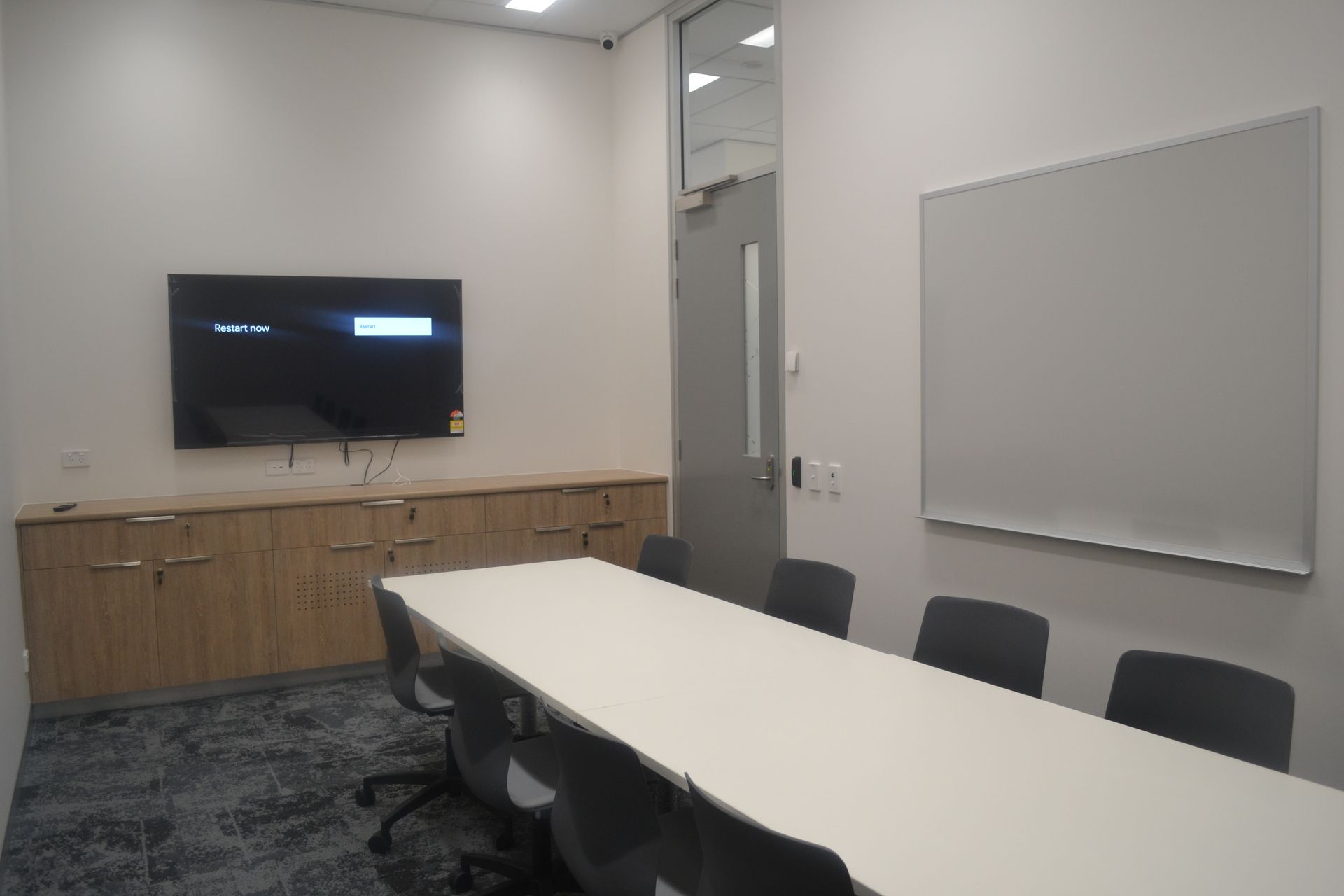 Conference Room With a Long White Table and Eight Grey Chairs — Nick Favot Painting In Bohle, QLD