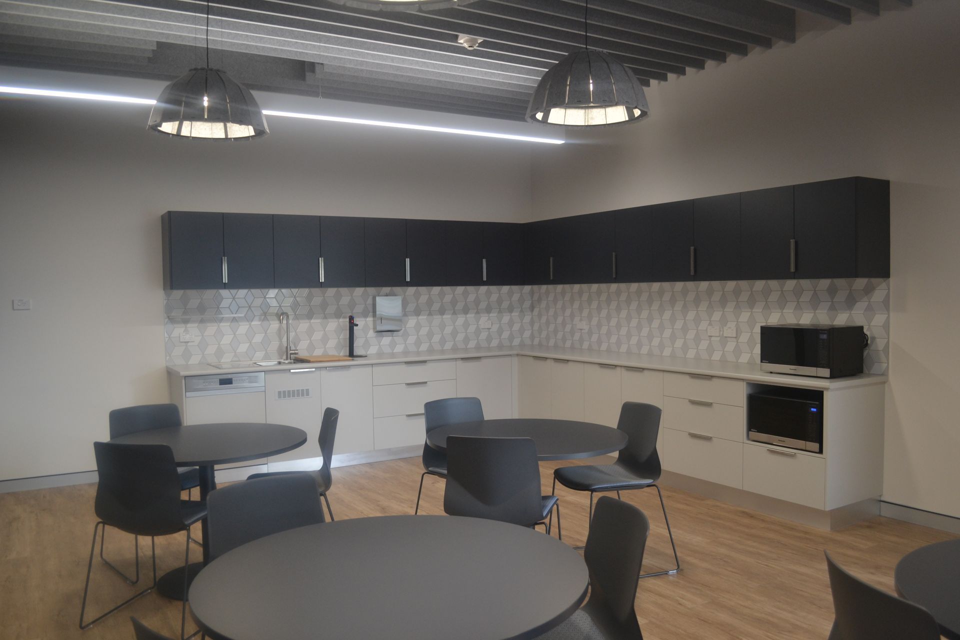 Modern Office Kitchen With Dark Cabinets — Nick Favot Painting In Bohle, QLD