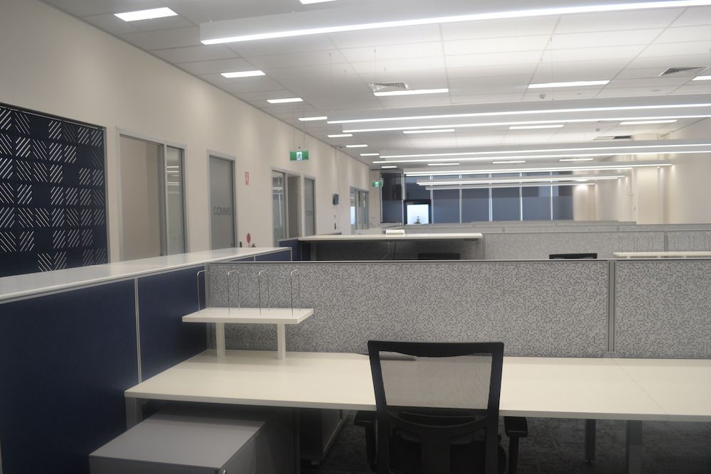 A Large Empty Office With a Lot of Desks and Chairs — Nick Favot Painting in Bohle, QLD
