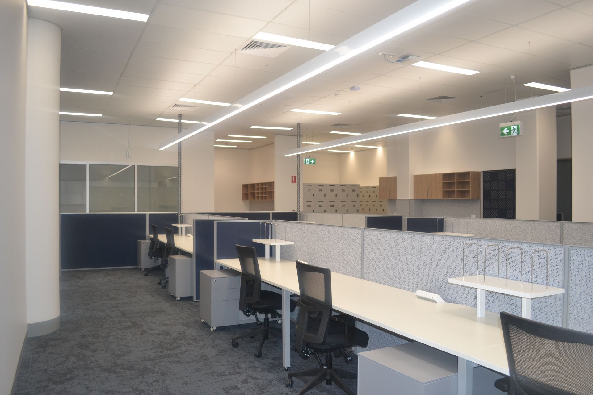 White Desks and Black Chairs Arranged in Cubicles — Nick Favot Painting In Bohle, QLD