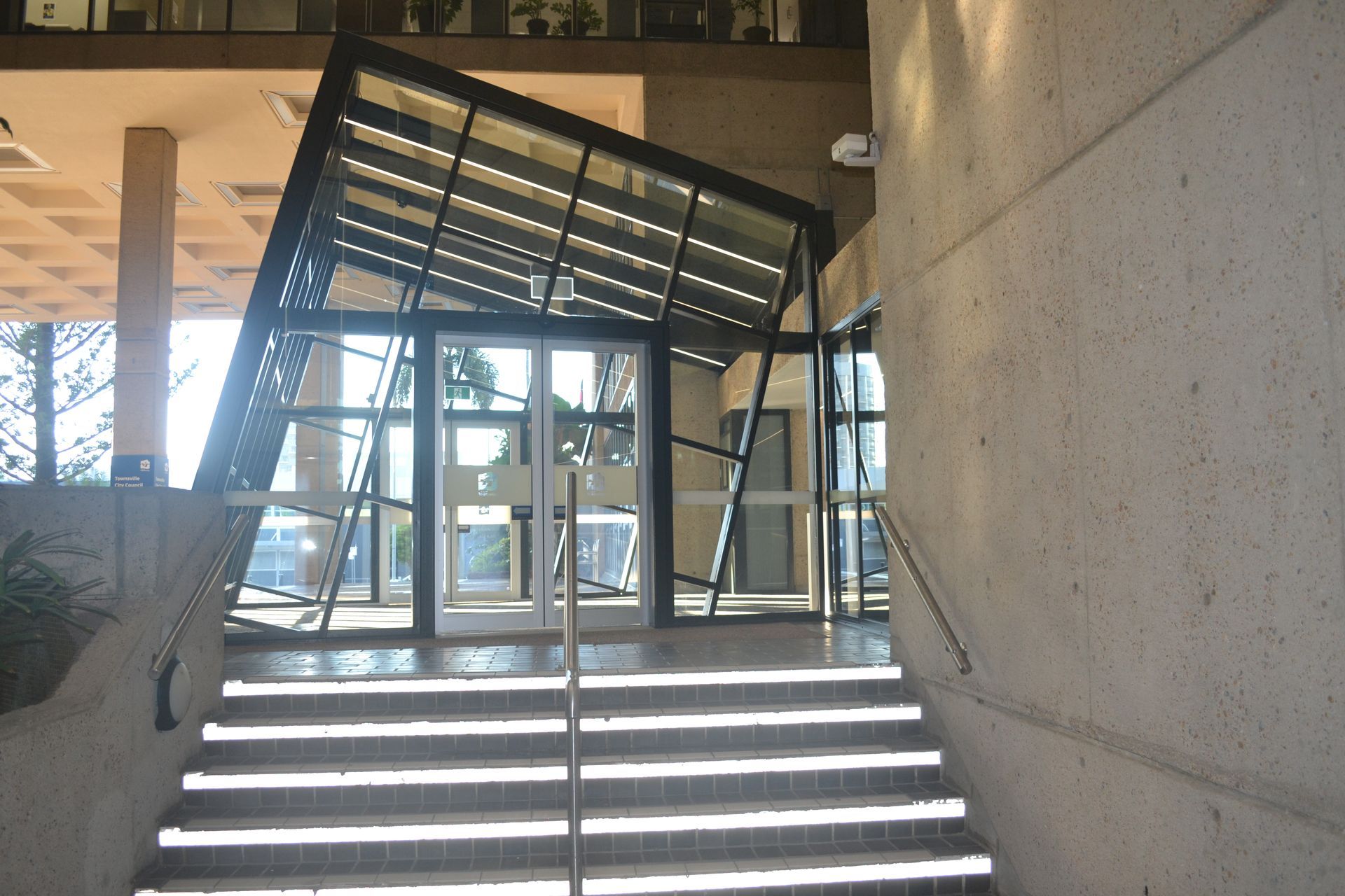 Tilted Glass Entrance of a Modern Building — Nick Favot Painting In Bohle, QLD