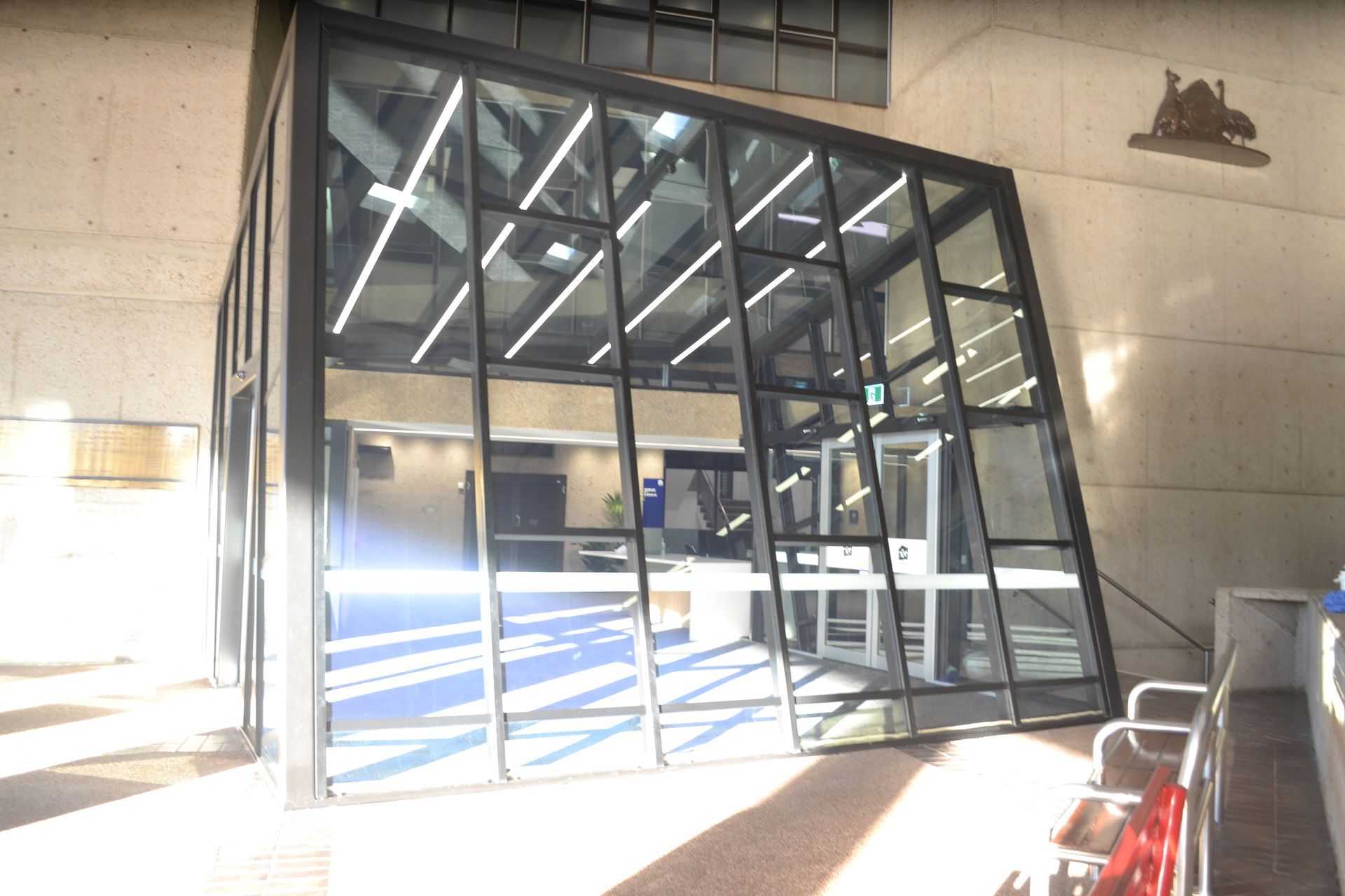 A Modern Glass Entrance With a Slanted Design — Nick Favot Painting In Bohle, QLD