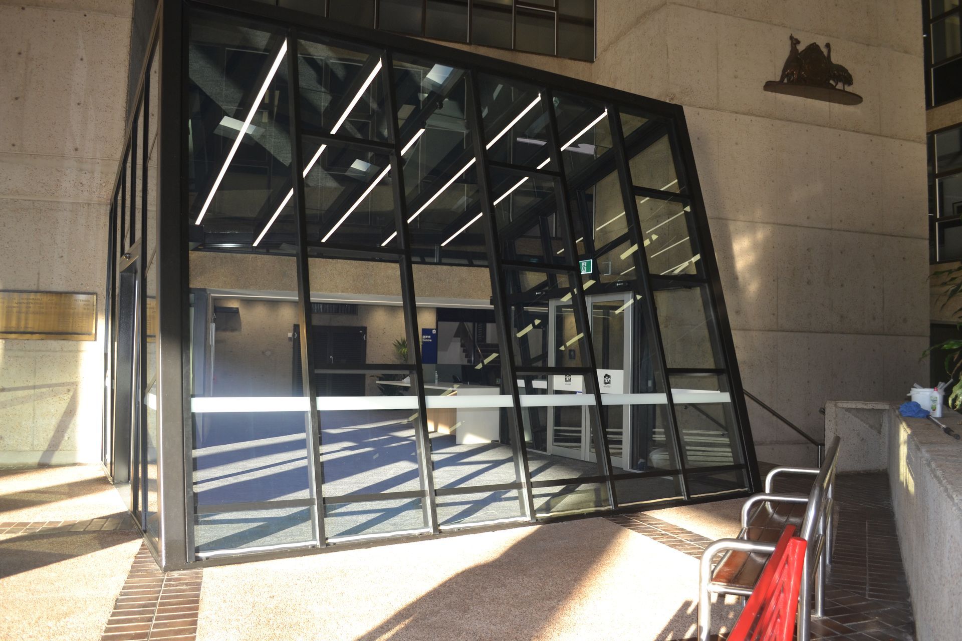 Tilted Glass Structure Entrance Surrounded by Concrete Walls — Nick Favot Painting In Bohle, QLD