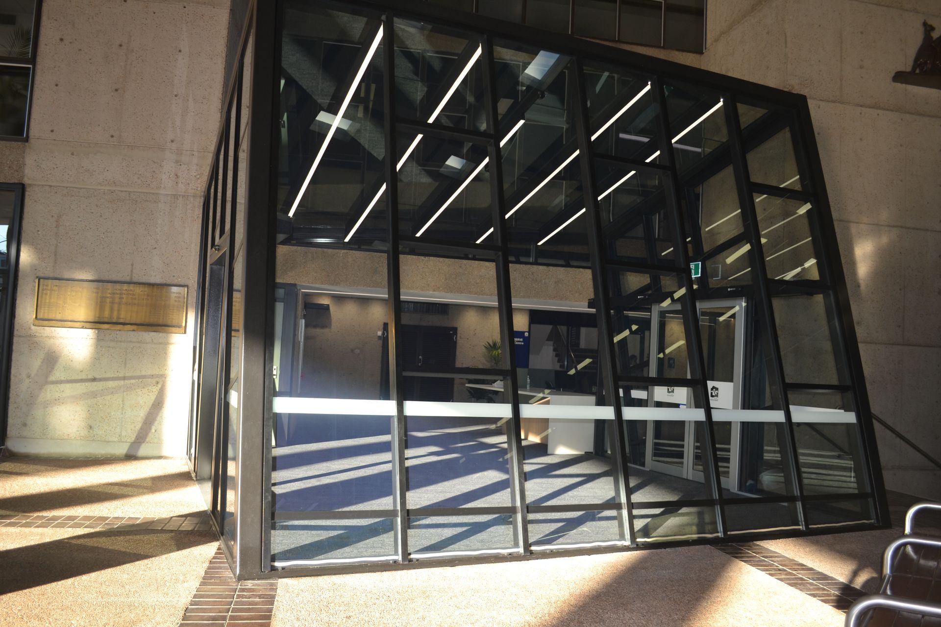 Glass Building Entrance With a Tilted Design — Nick Favot Painting In Bohle, QLD