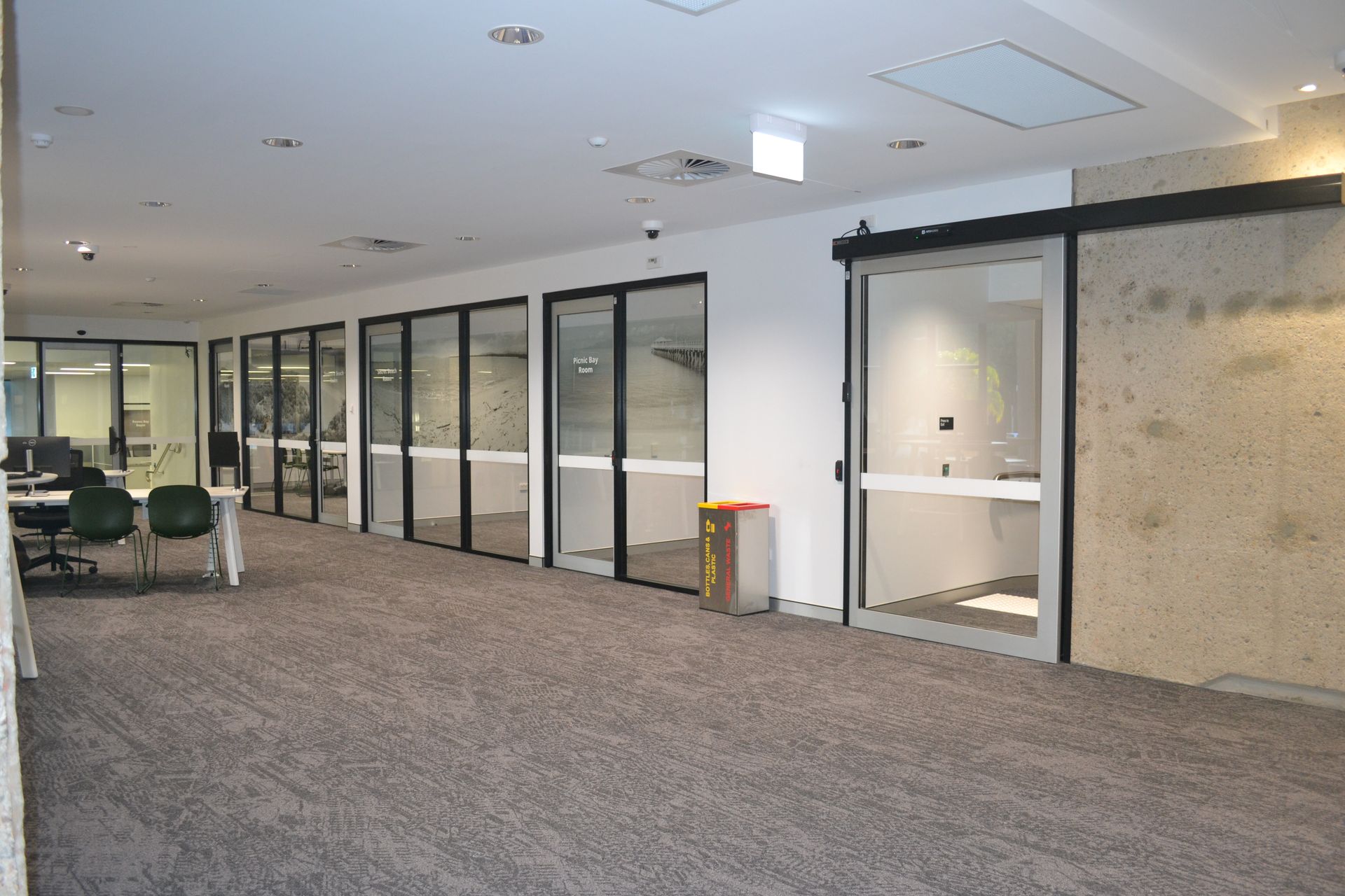 Office Hallway With Glass Doors and a Textured Beige Wall  — Nick Favot Painting In Bohle, QLD