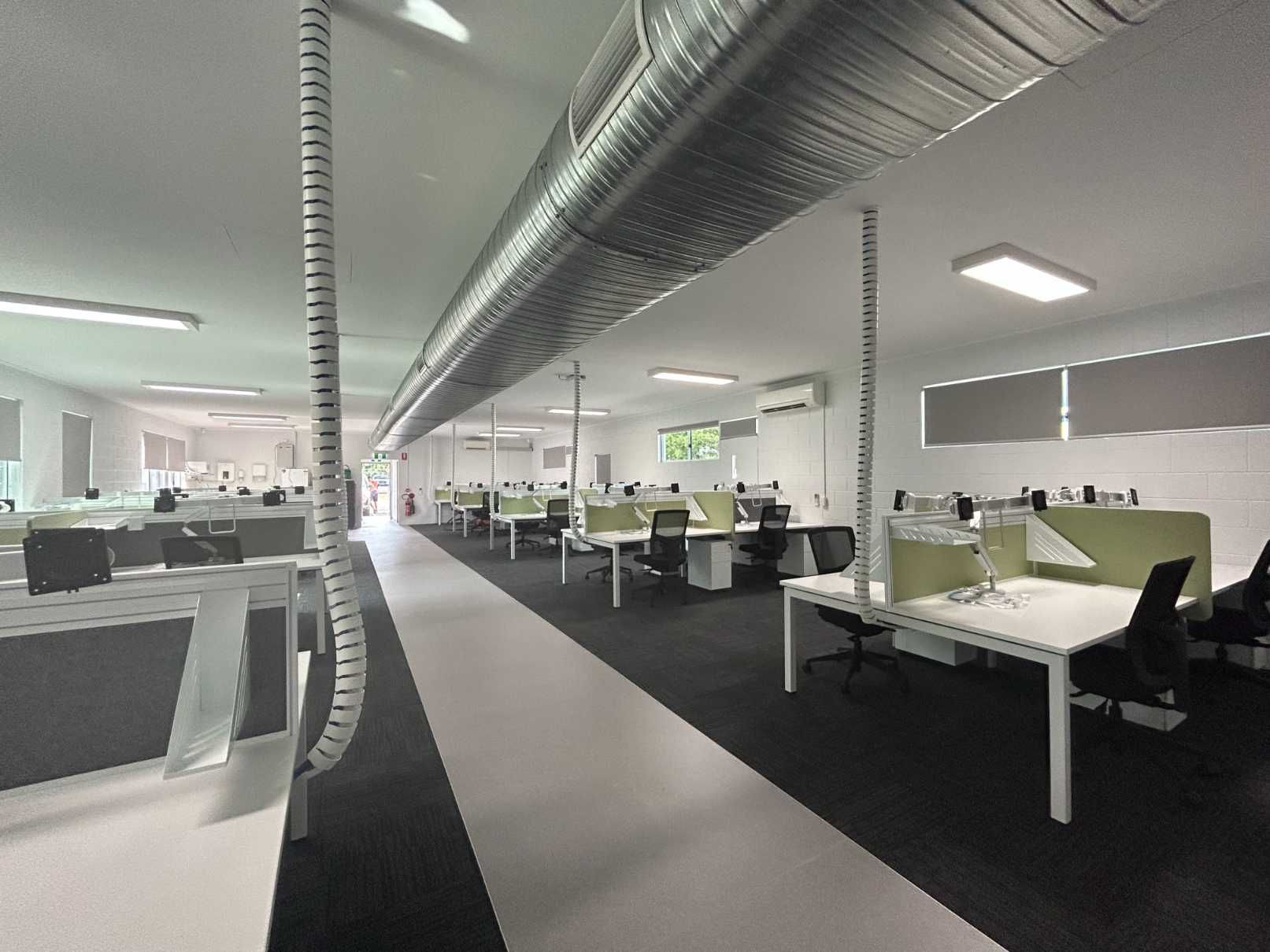 A Large Office With a Lot of Desks and Chairs — Nick Favot Painting in Bohle, QLD