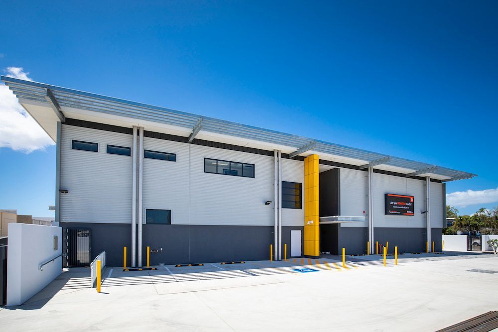 A Large Building With a Lot of Windows and a Blue Sky in the Background — Nick Favot Painting in Bohle, QLD