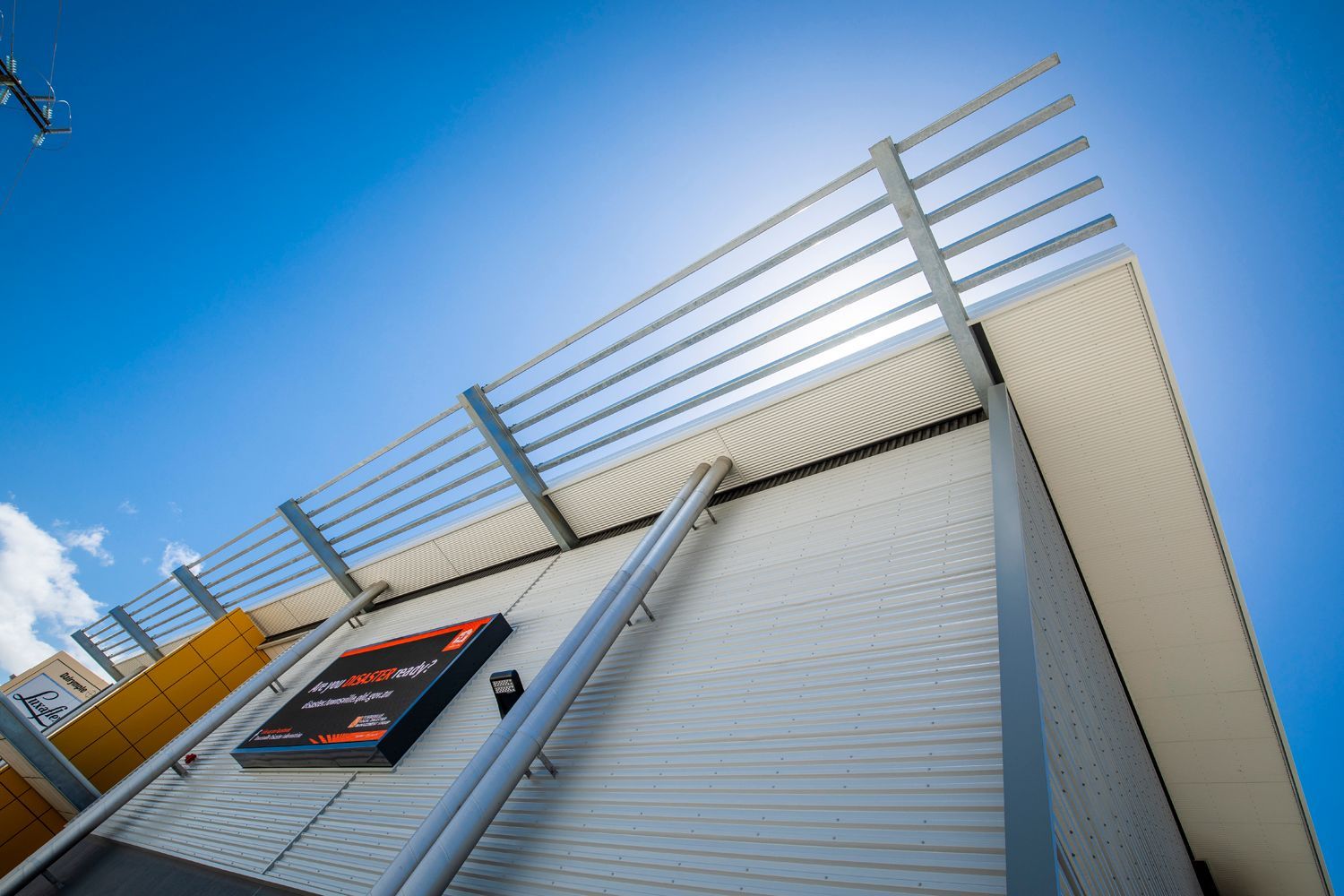 Modern Building Facade With Metal Panels and Pipes — Nick Favot Painting In Bohle, QLD