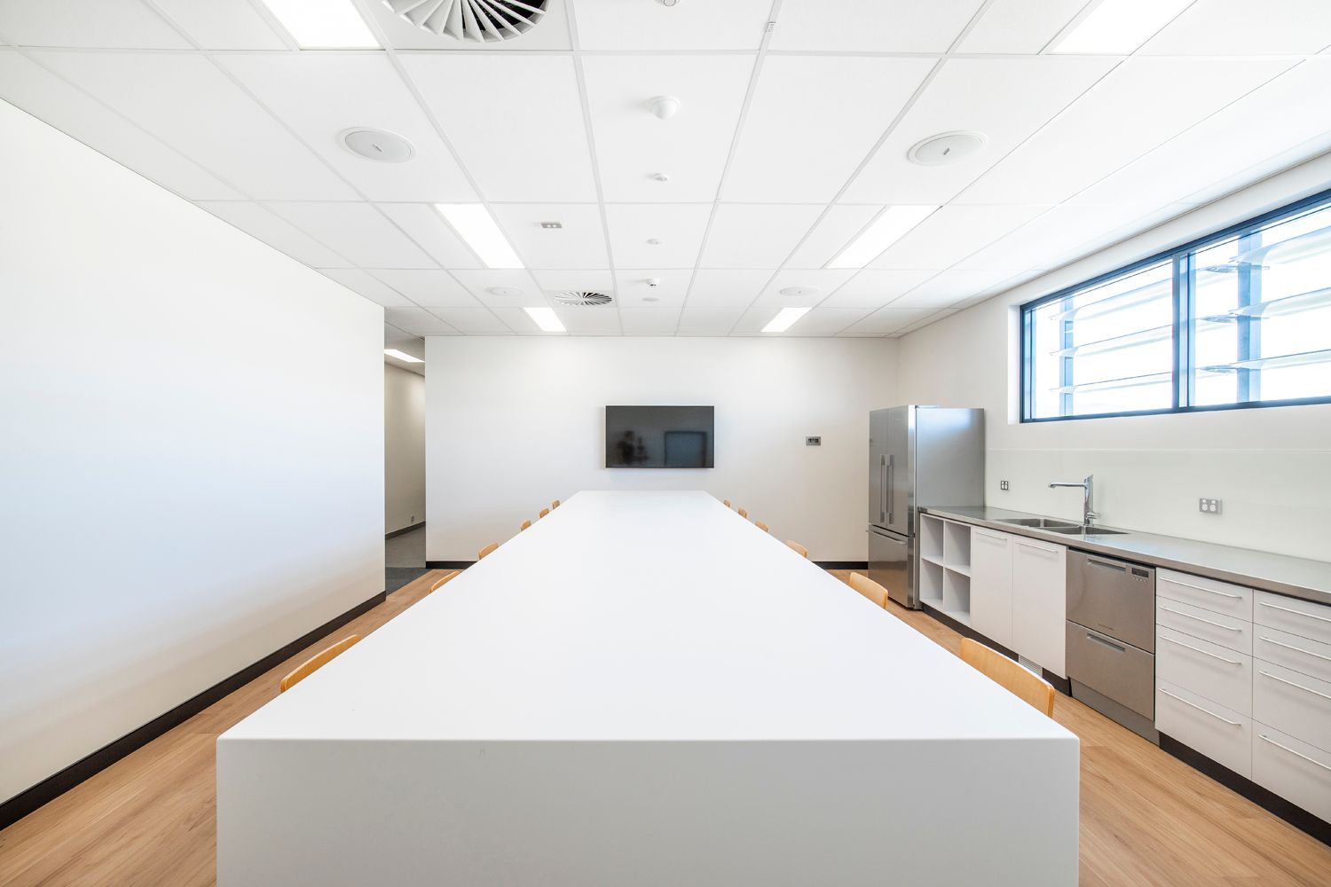Modern Kitchen With a Long White Island — Nick Favot Painting In Bohle, QLD