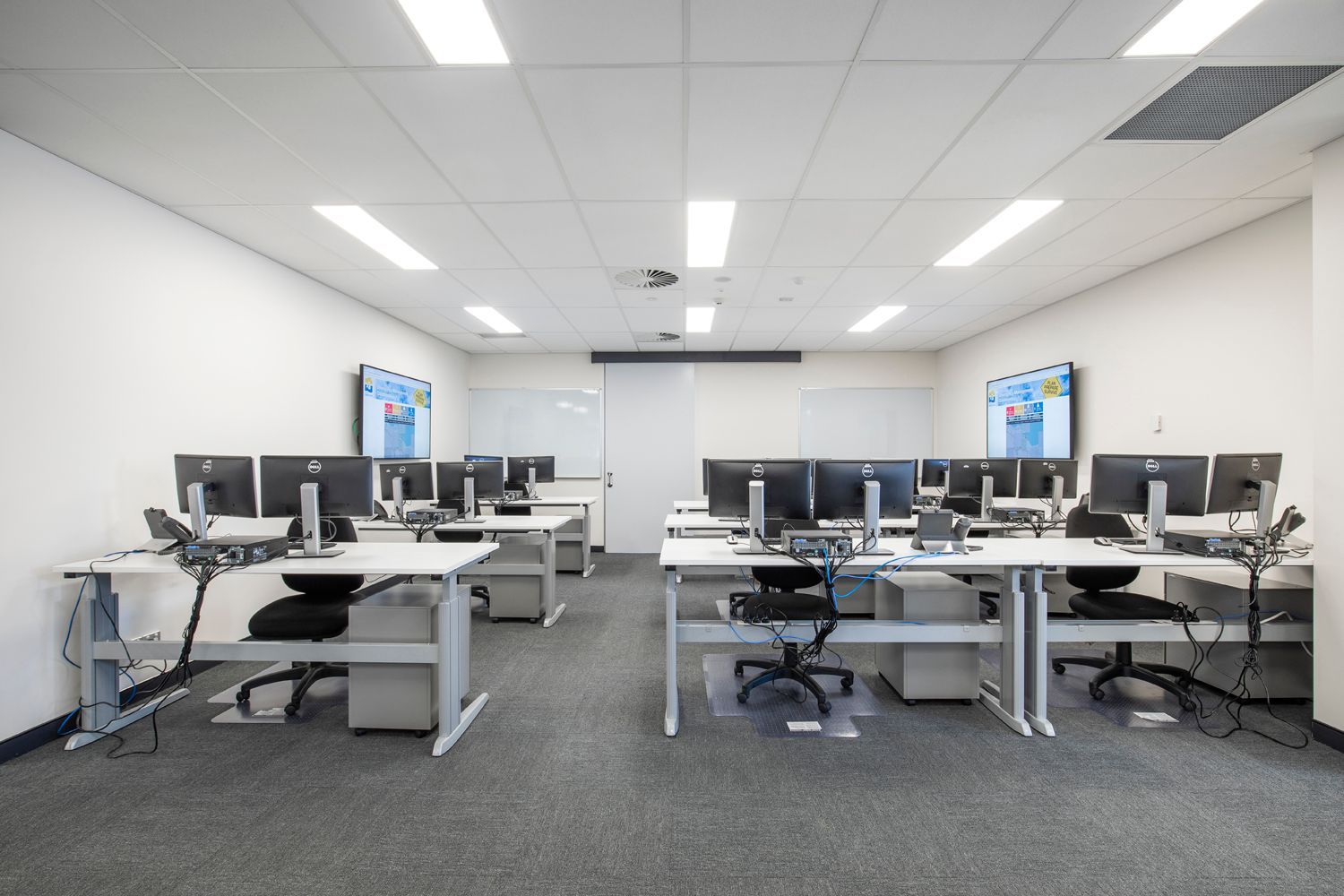 Modern Computer Lab With Desks, Each Equipped With Monitors and Chairs — Nick Favot Painting In Bohle, QLD