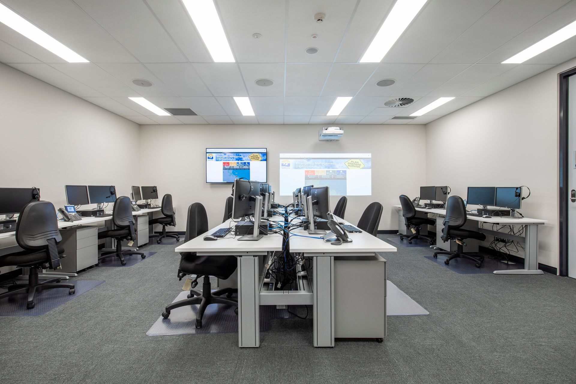 A Modern Computer Lab With Several Desks and Monitors — Nick Favot Painting In Bohle, QLD