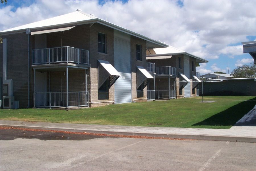 A Row of Apartment Buildings With Balconies and Awnings — Nick Favot Painting in Bohle, QLD