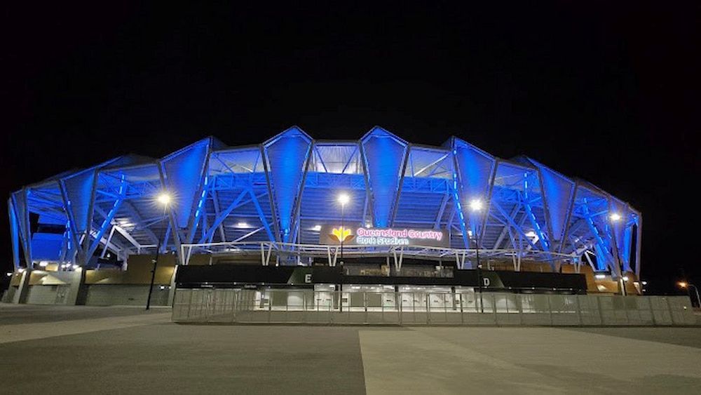 A Large Stadium is Lit Up With Blue Lights at Night  — Nick Favot Painting in Bohle, QLD