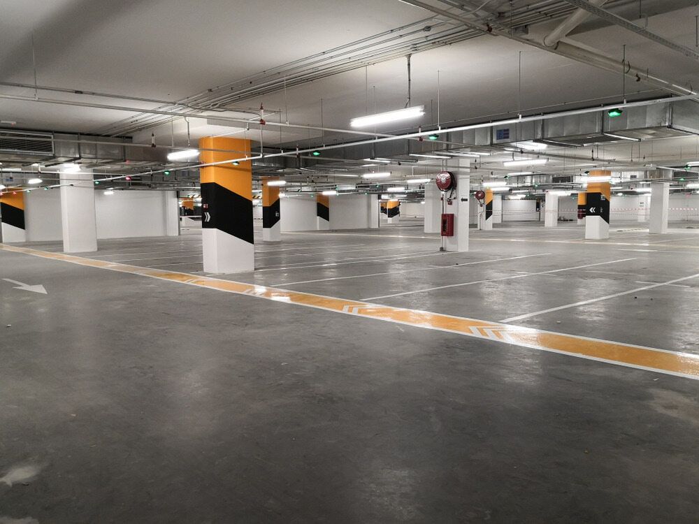 A Parking Garage With a Lot of Parking Spaces and Columns — Nick Favot Painting in Bohle, QLD