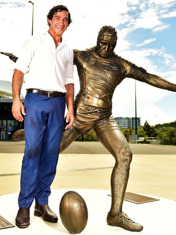A Man is Standing Next to a Statue of a Football Player — Nick Favot Painting In Bohle, QLD