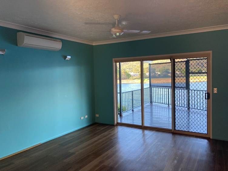 An Empty Room With a Ceiling Fan and Sliding Glass Doors — Nick Favot Painting in Bohle, QLD