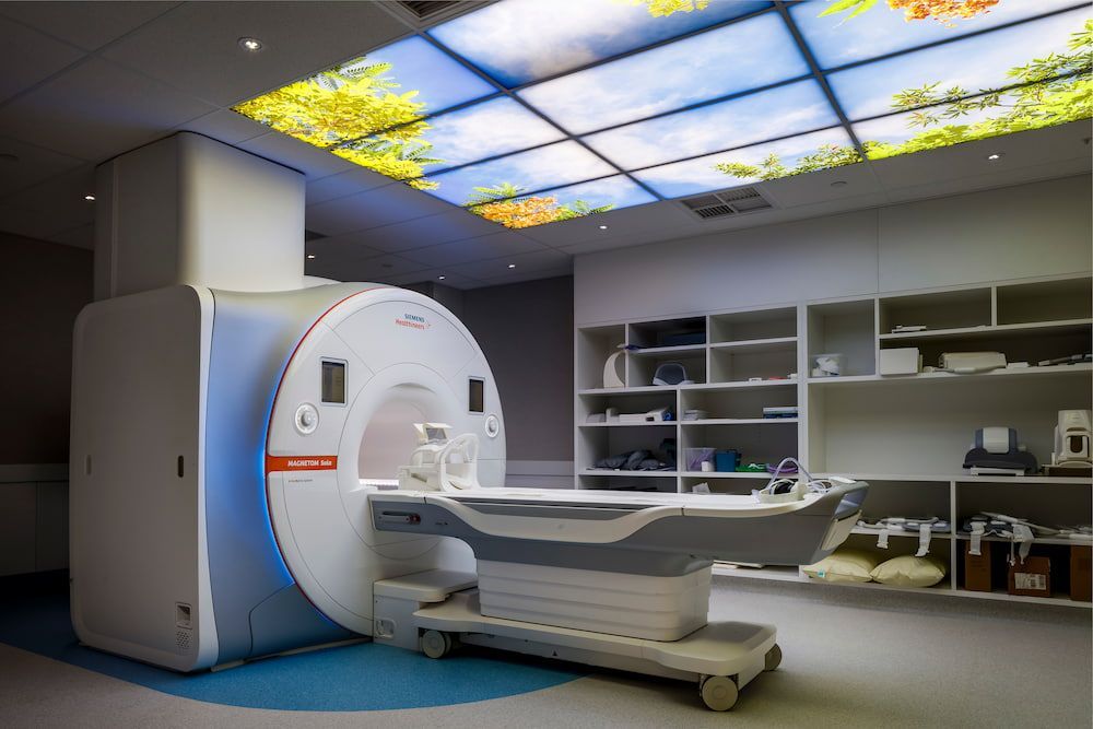 A Mri Machine is Sitting in a Hospital Room — Nick Favot Painting in Bohle, QLD