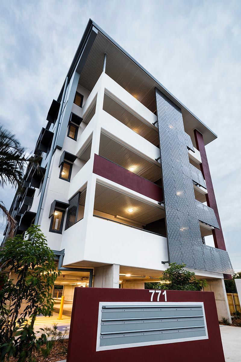 Modern Multi-storey Apartment Building With a White and Burgundy Facade — Nick Favot Painting In Bohle, QLD