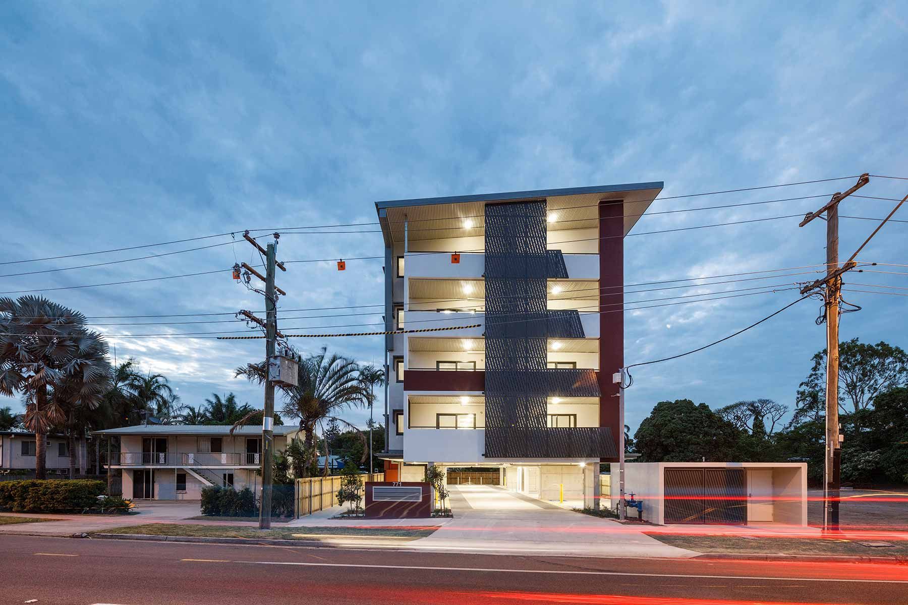 A Modern Apartment Building With Illuminated Balconies — Nick Favot Painting In Bohle, QLD