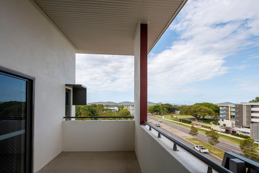 A Balcony With a View of a City and a Road — Nick Favot Painting in Bohle, QLD