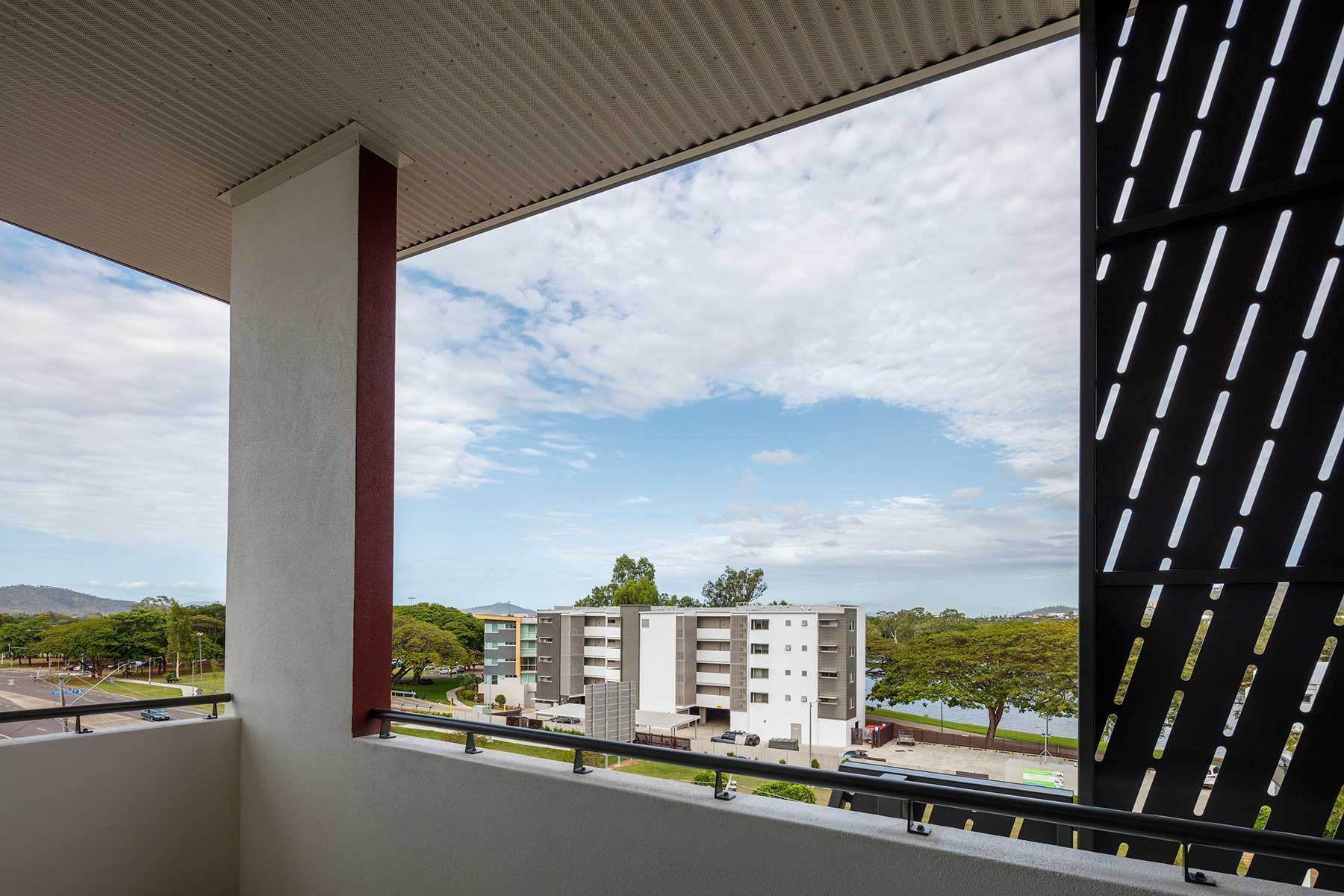 View From a Balcony Showing a Modern Apartment Building — Nick Favot Painting In Bohle, QLD