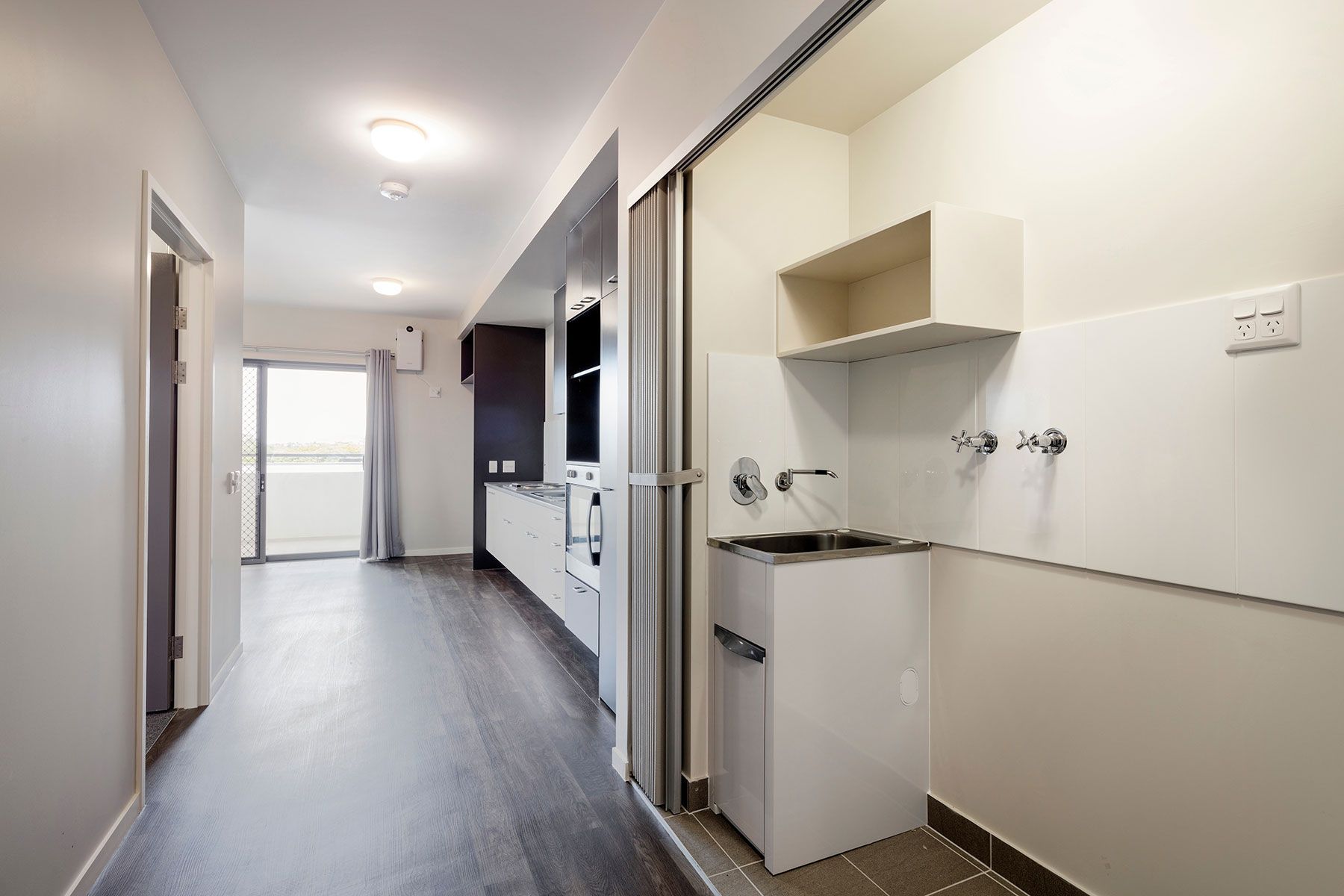 Apartment Interior With a Compact Kitchen and Laundry Area — Nick Favot Painting In Bohle, QLD