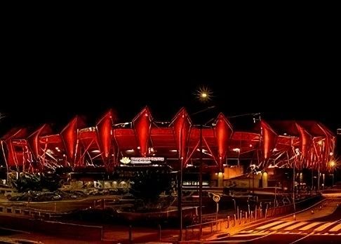 A Large Red Stadium is Lit Up at Night — Nick Favot Painting In Bohle, QLD