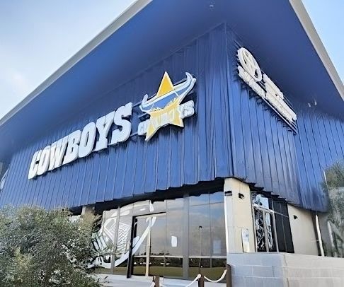 A Blue Building With the Word Cowboys on It — Nick Favot Painting In Bohle, QLD