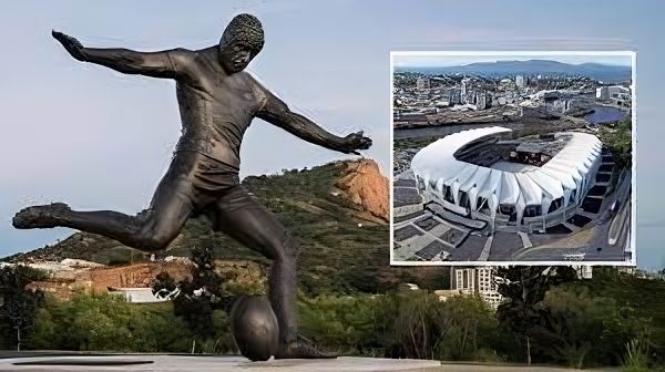 A Statue of a Man Kicking a Soccer Ball Next to a Picture of a Stadium — Nick Favot Painting In Bohle, QLD