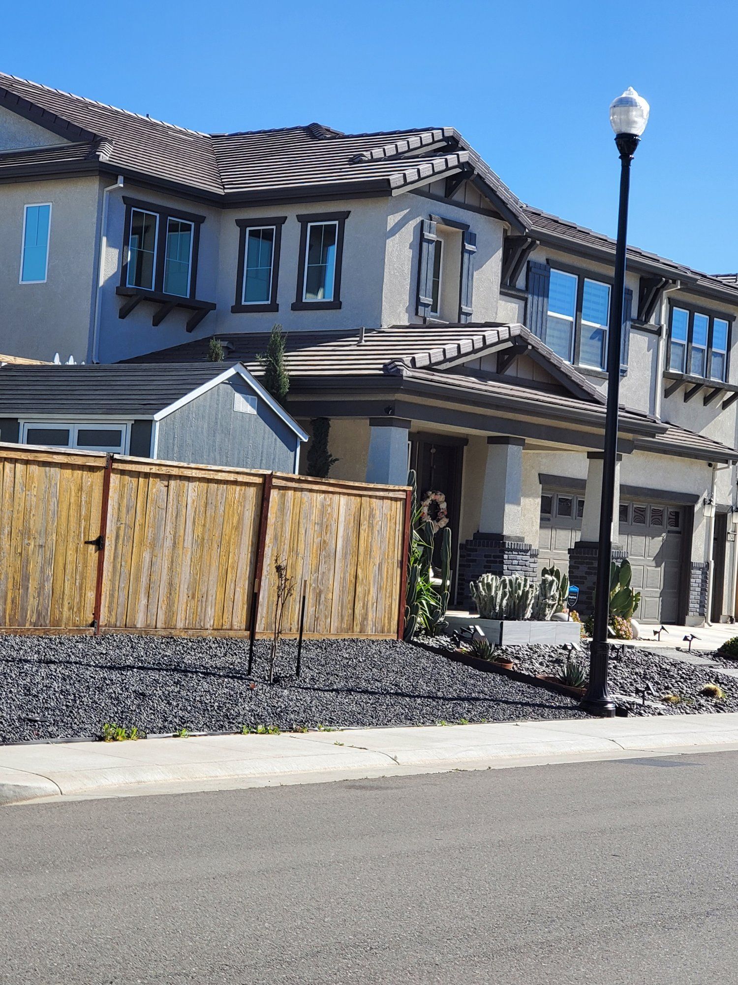 A large house with a wooden fence in front of it
